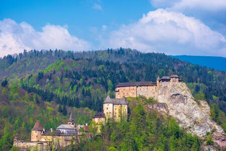 orava castle of slovakia. medieval fortress on a hill in a beautiful place in mountains. wonderful sunny weather with fluffy clouds in springtimeのeditorial素材