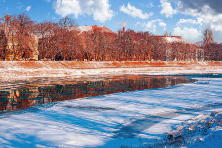embankment of the river in winter. cityscape on a sunny day. reflection on the water