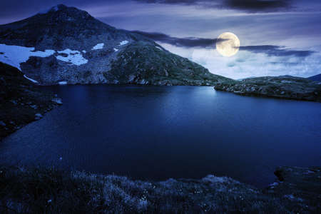 summer scenery with lake on high altitude at night. beautiful landscape of fagaras mountain ridge in...