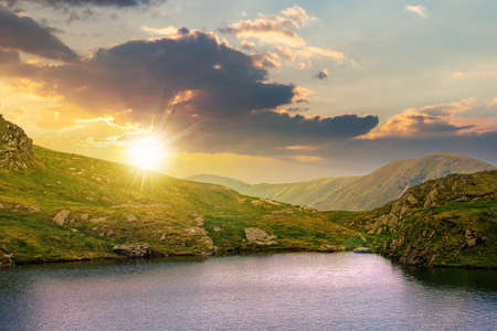 summer landscape with lake on high altitude at sunset. beautiful scenery of fagaras mountain ridge...