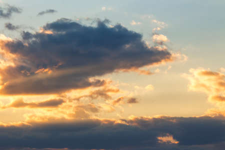 dramatic sky at sunset. beautiful cloud formations in evening lightの写真素材