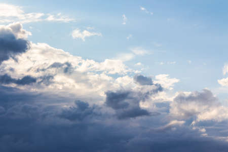 clouds on the blue sky in morning light. stormy weather approaching in summerの写真素材