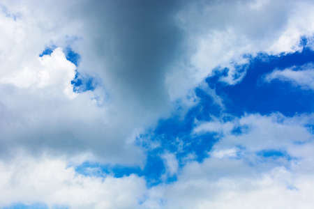 fluffy cumulus clouds on a blue sky. beautiful nature background in morning lightの写真素材