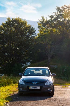 mizhirya, ukraine - AUG 08, 2020: car parcked near the forest. beautiful nature scenery in morning...