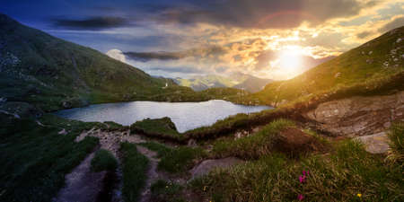 day and night time change concept above mountain landscape with lake in summer at twilight....