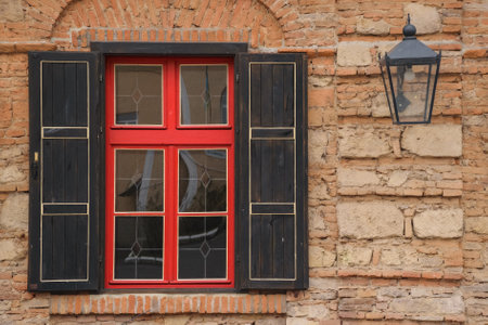vintage wooden window on the ancient facade. old lantern on the wall