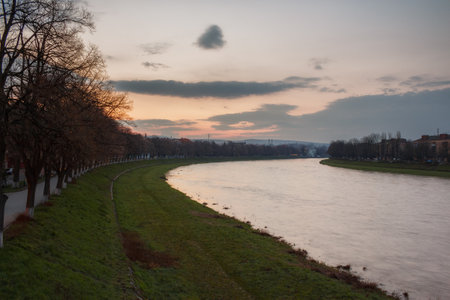 uzhhorod cityscape at dawn. linden alley on the embankment. gorgeous cloudscape above the riverの写真素材