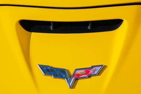 uzhgorod, ukraine - 31 oct 2021: shabby chevrolet corvette logo on a yellow hood. outdoor close upのeditorial素材