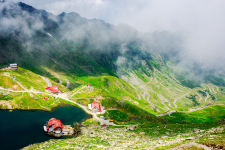 landscape of high altitude mountain lake in summer. nature scenery of valley with transfagarasan...