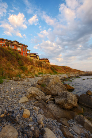 pebble beach of bulgaria at sunrise. gorgeous view of seascape on a cloudy morning. relax and recreation at the black seaの写真素材