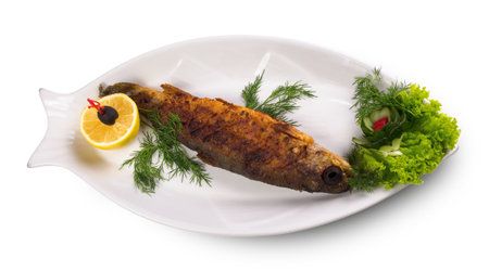 fried fish on the white plate. tasty dish. top view