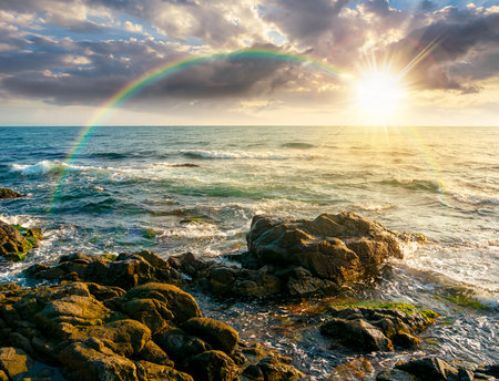 sea coast with rocks and boulders at sunset. calm summer vacation background at the seashore. wonderful scene for relax and leisure at the seaside in evening lightの写真素材