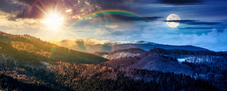 panorama of distant mountain ridge with snowy top. day and night time change concept. beautiful forested rolling hill of a countryside with sun and moon at twilight. duality and transition templateの写真素材