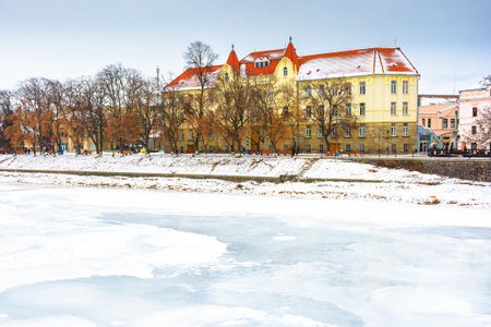 uzhhorod, ukraine - 09 jan 2017: christmas time in the old town in winter. snow covered embankment of ice frozen river uzh. cold weather. timeless photo of transcarpathia capital on holiday seasonのeditorial素材
