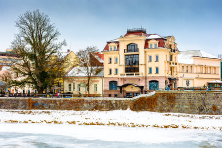 uzhhorod, ukraine - 09 jan 2017: christmas time in the old town in winter. snow covered embankment of ice frozen river uzh. cold weather. timeless photo of transcarpathia capital on holiday seasonのeditorial素材