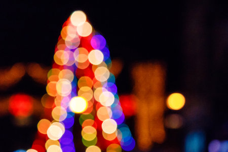 outdoor scene defocused christmas tree. festive abstract background of street for new year with...