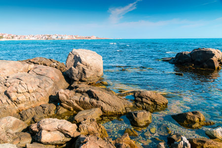 rocky shore of the sea coast under blue sky. beautiful view of coastal bulgaria on a sunny day. resort scenery near sozopol during vacation season in summer. place for vacation, retreats and escapeの写真素材