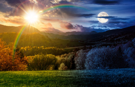forested hills on spring equinox. day and night time change concept. beautiful scenery in mountains with sun and moon at twilight. rolling countryside landscape. harmony and progress calendarの写真素材