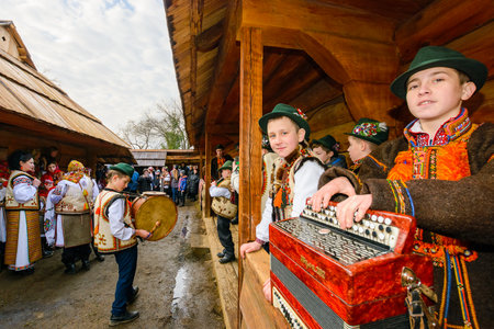 uzhhorod, ukraine - 13 jan, 2018: hutsuls singing christmas carols outdoor. folk music festival during winter holiday of ts. basil. group of children in traditional closes having funのeditorial素材