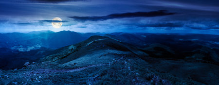 beautiful landscape of mountainous area on a summer night. panoramic view of great ridge in dappled...
