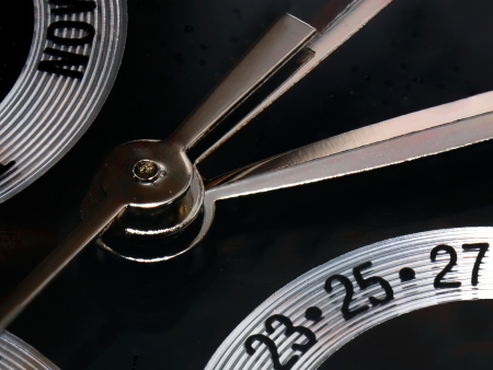 a closeup of a clock showing day and dateの写真素材