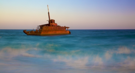 shipwreck on a beach at duskの写真素材