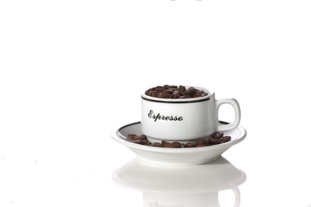 a coffee cup filled with beansの写真素材