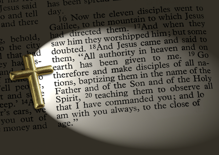 The bible passage Matthew 28:18-20, lit up by the crossの写真素材
