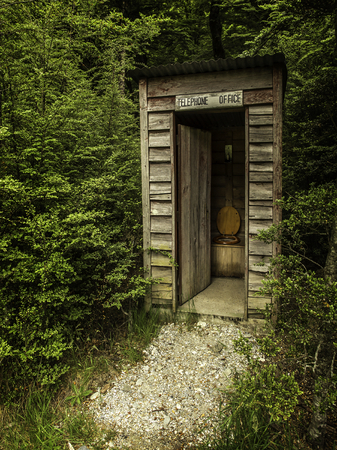 an outhouse pretending to be a telephone boothの写真素材