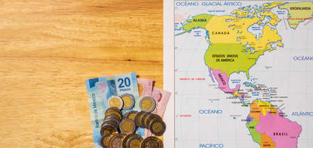 Concept of travel with little money around the world with a map a cell phone