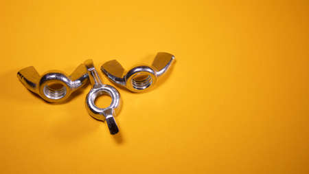 Butterfly nut in yellow background, allows manipulation by hand. Also called sequined nutの写真素材