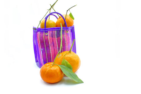 Mexican style bag for the errand or to go to the market, with tangerines inside on a white backgroundの写真素材
