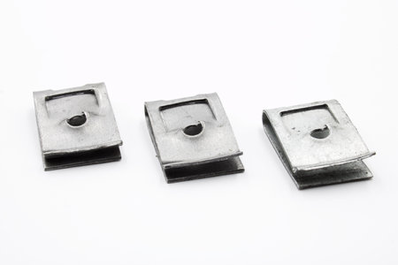 Metal automotive clip for trim on a white background