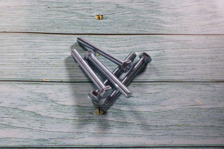 Galvanized hex head screw on wooden backgroundの写真素材