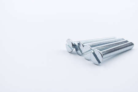 Galvanized screw with flat head running string for flat head screwdriver on a white backgroundの写真素材