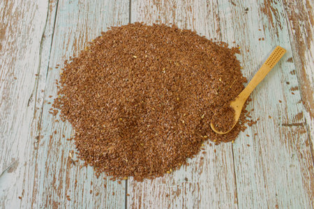 Flaxseed distributed on a wooden table, it is used for digestion and improves healthの写真素材