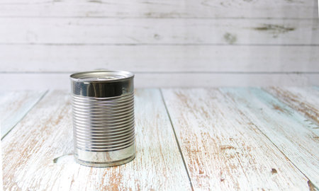 Metal tin on a wooden background, no labels