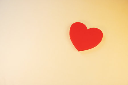 Red heart on yellow background. Valentines day concept. Copy space.の写真素材