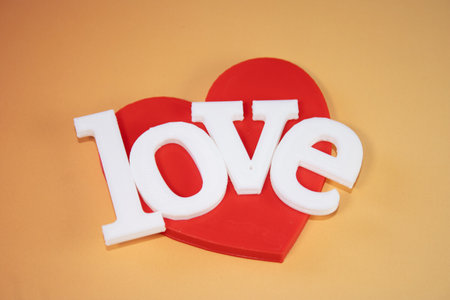 Word love on an orange background. Valentines day greeting card.の写真素材