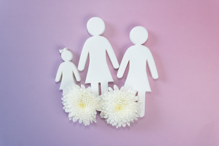 White paper family with chrysanthemum flower on pink backgroundの写真素材