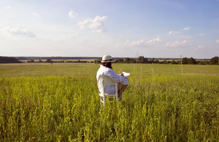 Woman Sitting on Meadow and Drawing Country