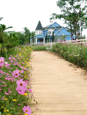 The road to the house with flowers on pathwayのeditorial素材
