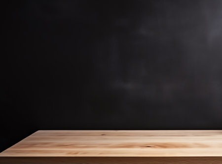 Blank wooden tabletop on blackboard wall background, mockup and display for kitchen and restaurantの素材