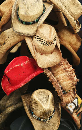 red cowboy hat surrounded by yellow cowboy hatの写真素材