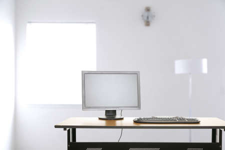 modern setting of contemporary empty office space with computer screen and keyboard