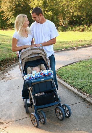 young caucasian parent walking their baby outdoor in park