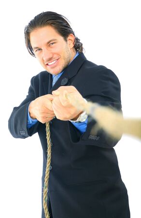 young male businessman struggle to pull a rope. concept for business competitionの写真素材