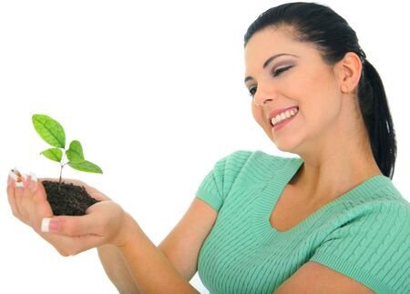 happy young woman holding new life in form of plantの写真素材