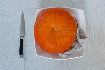Halloween Orange Pumpkin in a Plate on a White Floor.の写真素材