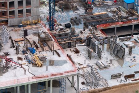 Building top view. Building materials, fittings and concrete walls at the construction site.